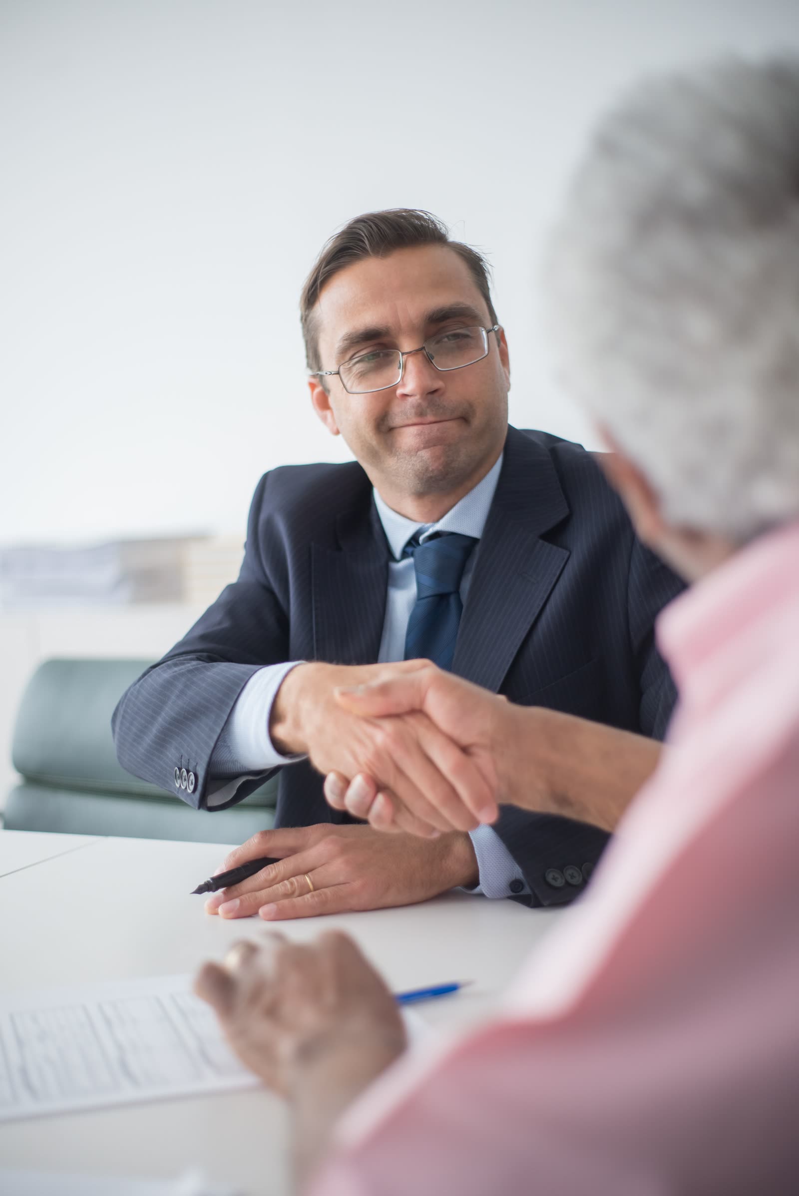 A professional in focus meeting with clients across a desk