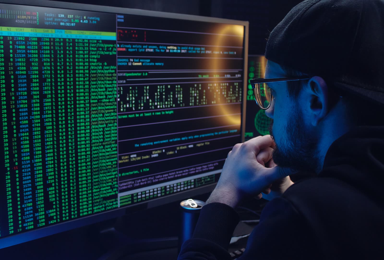 A professional sitting at a desk, pausing and looking at a computer screen
